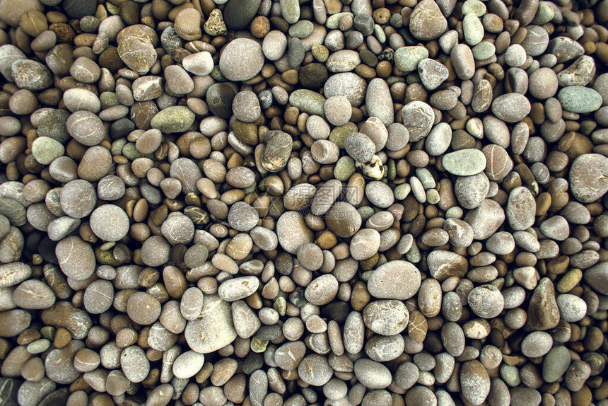 海边的小圆卵石灰色的石头鹅卵石的背图片