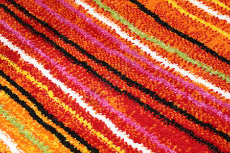 斜面彩色线条的地毯背景的详细节图片