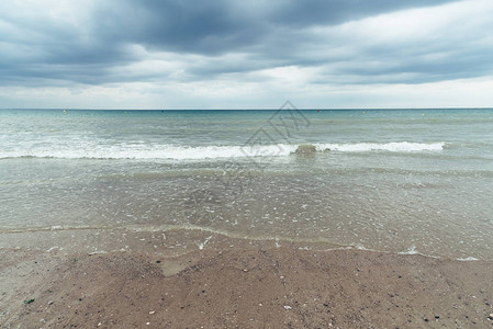 海滩有乌云和即将来临的暴风雨与恶劣天气图片