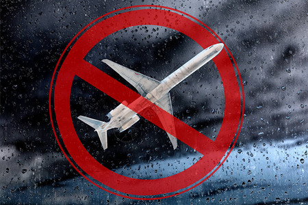 这架飞机以雷云和红色的禁止符号为背景非飞行天气和禁止飞行的概图片