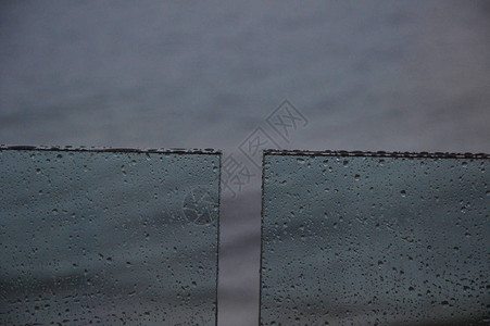 雨落在有海背景的窗户上图片