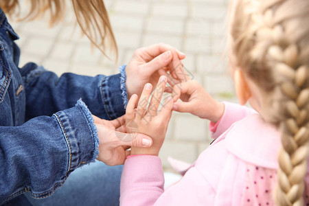 妈教聋哑女儿在户外使用手语背景图片