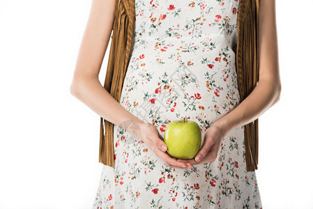 以白色隔绝的绿苹果为隔离位置的孕妇的作图片
