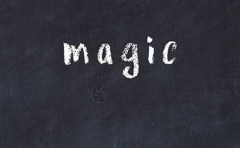 黑桌上的粉笔手写题词魔术背景图片