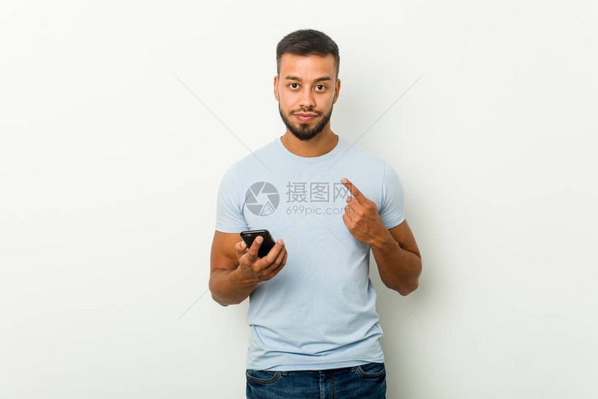 年轻混血的亚洲男子拿着电话图片