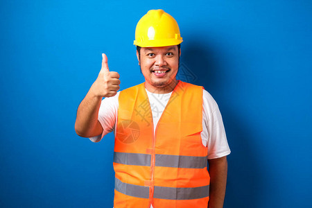身穿橙色安全背心和头盔的胖亚述建筑工人图片