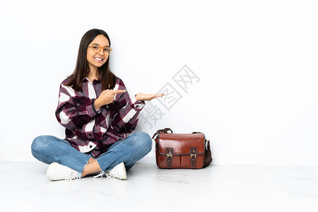 坐在地板上的年轻女学生背景图片