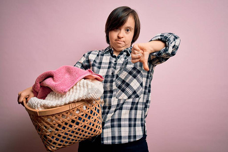 做家务的年轻唐氏综合症妇女拿着洗衣柳条篮图片