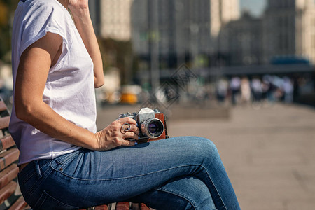 女人在户外拿着复古老式相机旧相机美图片