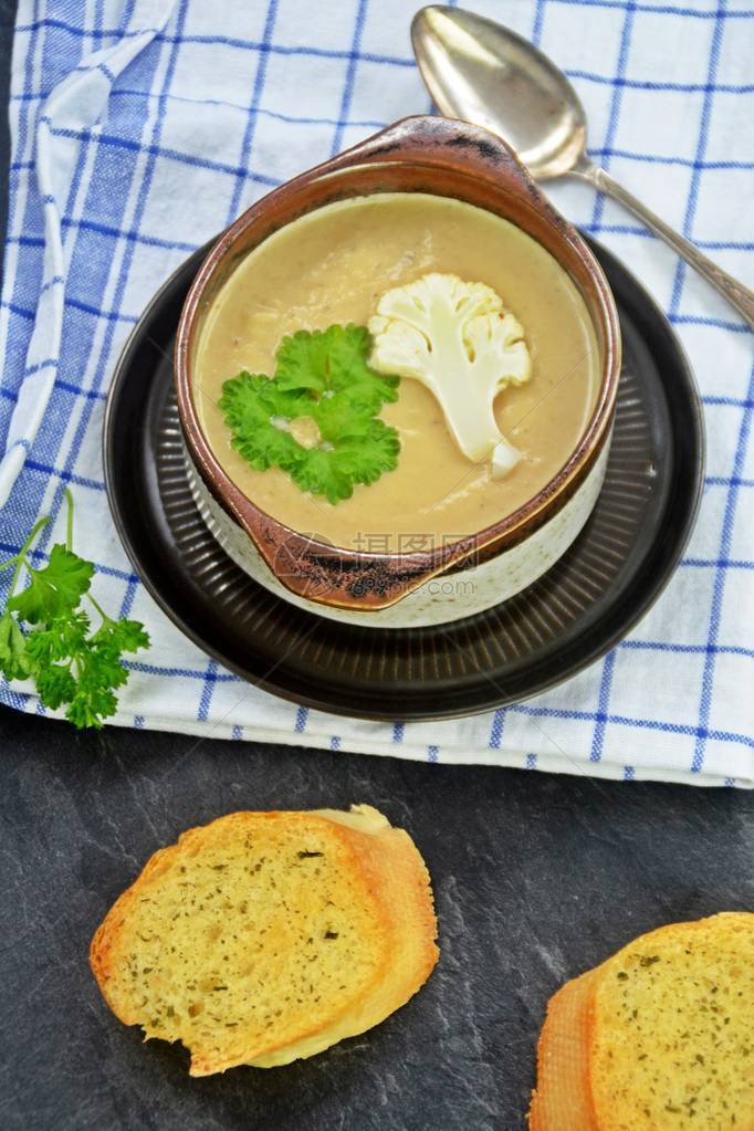 新鲜自制的花椰菜汤配欧芹和烤白面包图片