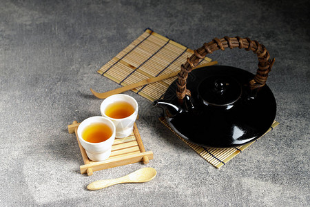 玻璃茶壶和蒸汽杯中的热茶图片