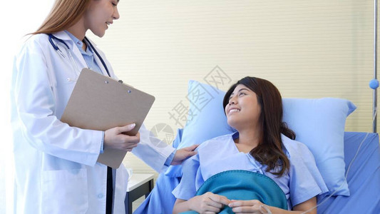 女医生和患者在医院疗治诊所接受专业家诊断咨询图片