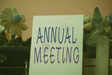 手写文本年会组织一般会员的概念照片年度会议鲜花和书写设备以及纹理背景图片