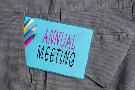概念手写显示年会概念意义组织一般会员年会书写设备和裤袋中背景图片