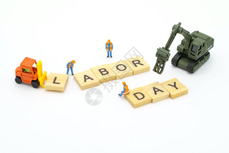 微型人物站在木字劳动节作为背景通用日概念和健康日概念图片
