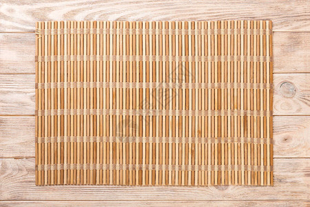 空的亚洲食品背景棕色竹子垫在木制背景顶端视图上图片