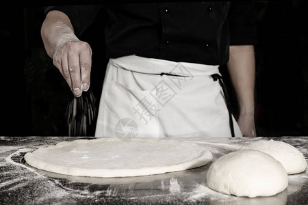 厨师用面粉准备面团做比萨饼图片
