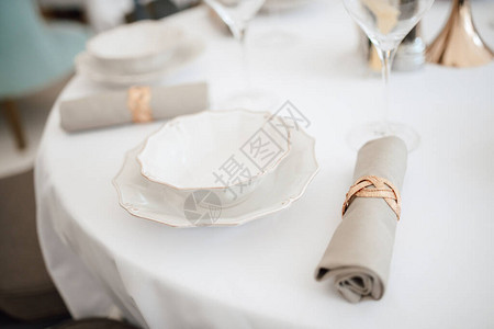 为宴会提供白色餐桌带酒杯的餐桌宴会用白色餐桌配有酒杯和盘子的餐图片