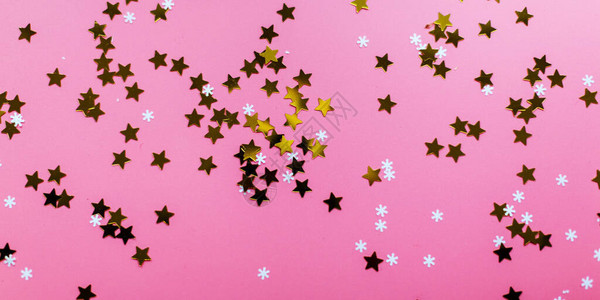 星和雪花在粉红色背景上图片