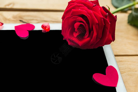 情人节婚礼或母亲节贺卡上的模型平板牌上红玫瑰和装饰心复图片