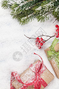 圣诞贺卡与礼品盒和冷杉树枝在雪背景圣诞背景顶视图与空间为您图片