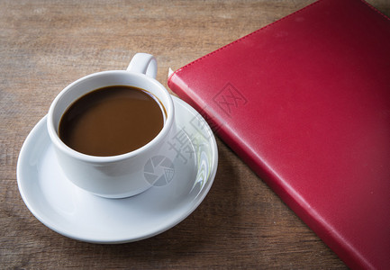 杯咖啡书在桌子木头上图片