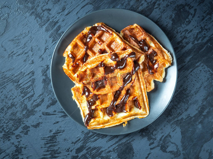 三个华夫饼和巧克力在灰色背景特端视图图片