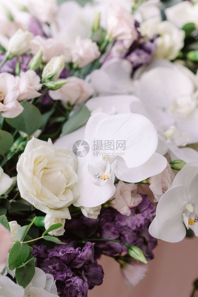 新婚夫妇的婚桌装饰着新鲜白玫瑰和兰花图片