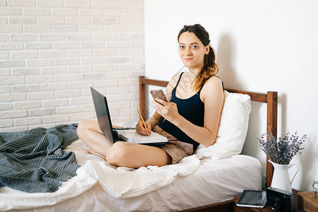 使用笔记本电脑的欧洲年轻女在家远程工作图片