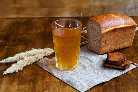 夏季软饮料杯自制面包格瓦斯与复制空间用麻布在木桌上的啤酒和黑图片