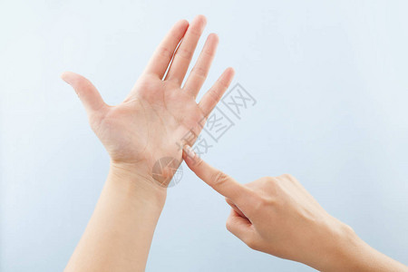 女用蓝背景孤立的手显示聋哑人BSL字母T图片