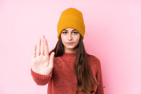身着羊毛帽的年轻caucasian女人站立伸展的手显示停图片