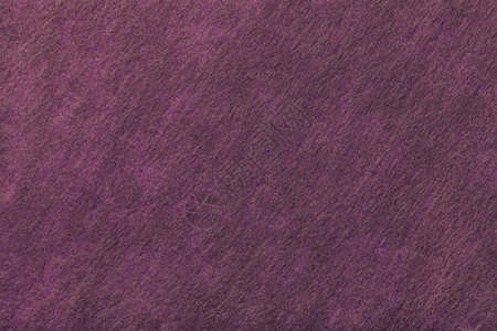 深紫色背景的结构与毛毡织物的棕色斑点图片