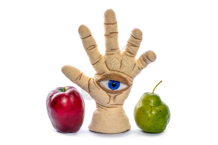 用白色背景上的苹果和梨制成的毡状羊毛制成的手掌和眼睛形状图片