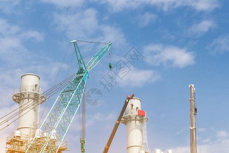 有起重机的许多塔式建筑工地和蓝天背景的建筑图片