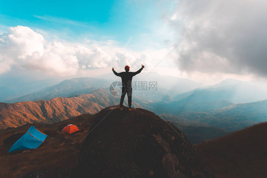 人类的休光灯举起手来抓住山峰图片