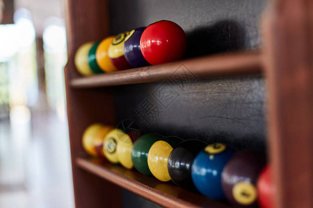 架子上的台球用美式台球的台球木制背景上的台球用彩色或白色背景图片