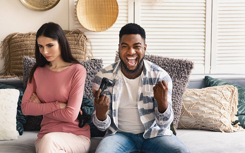 非裔美国人的丈夫对赢取电脑游戏感到欢欣鼓舞图片