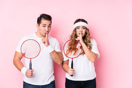 玩羽毛球的年轻夫妇孤立地保守秘密或图片