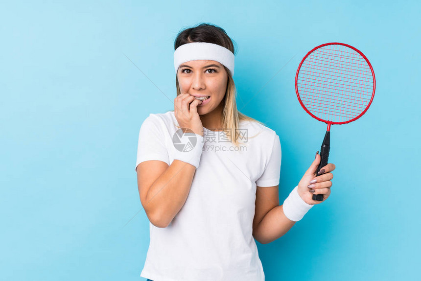 玩羽毛球的年轻天主教女孤立的咬指甲图片