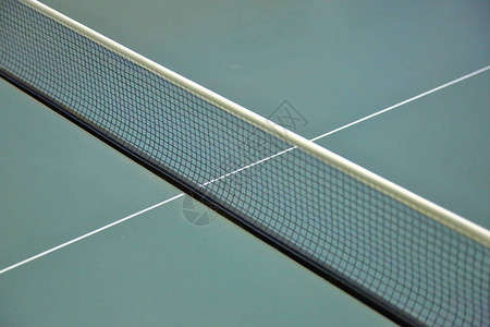 绿色乒乓球台上张开的窄布网图片