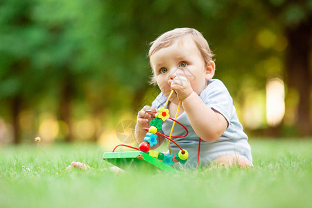 健康可爱的小孩男在草地上玩图片
