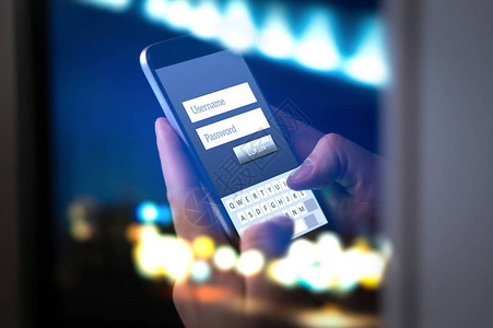 晚上用智能手机登录网上银行账户或网上个人信息双手在黑暗中输入用户名和密码到应用程序网络安背景图片