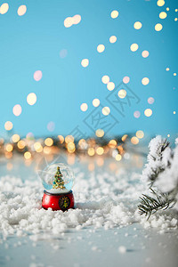 雪球中的小圣诞树站在蓝色上图片