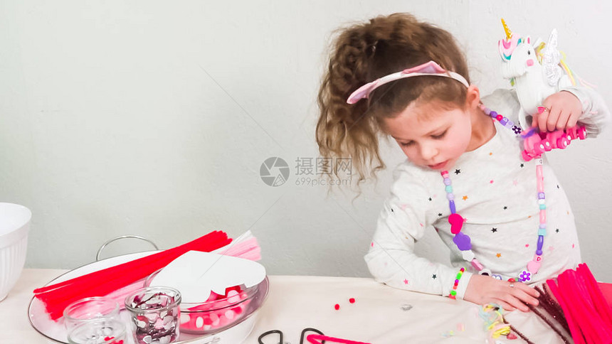 小姑娘用白纸和粉色纸泡沫制造独图片