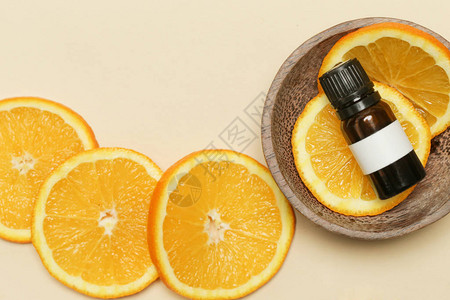 橙精油小瓶子和橙片工作室拍摄背景图片