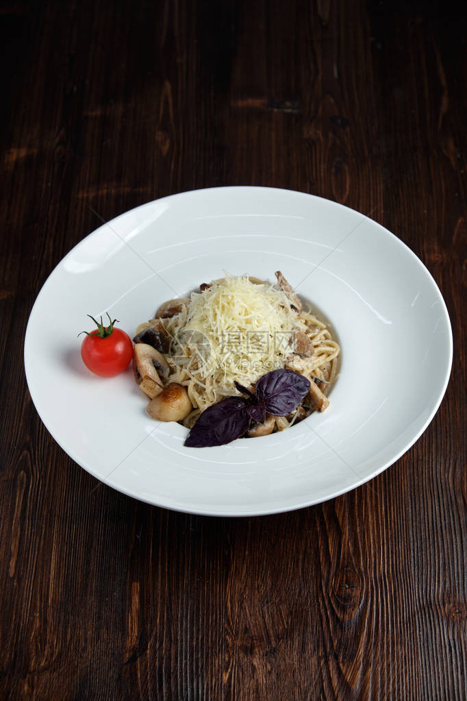 面粉和蘑菇放在白色盘子上边菜在黑木背景图片