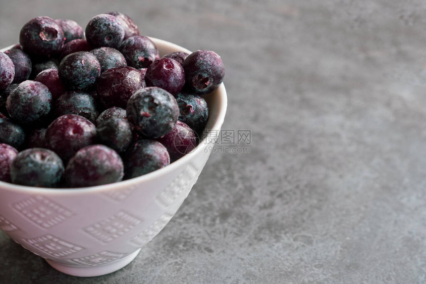 冰冻的蓝莓和冰冻的蓝莓坐在白碗里仍图片