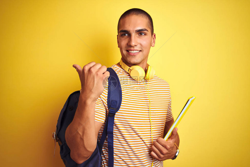 年轻学生男子戴着耳机和背包图片