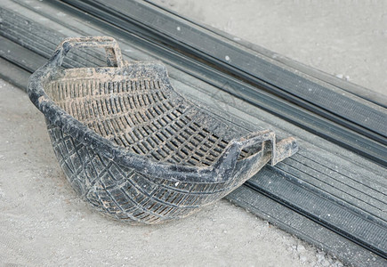 蛤壳篮用于在水泥地板上安装砖头石块粘土建筑中的沙子图片